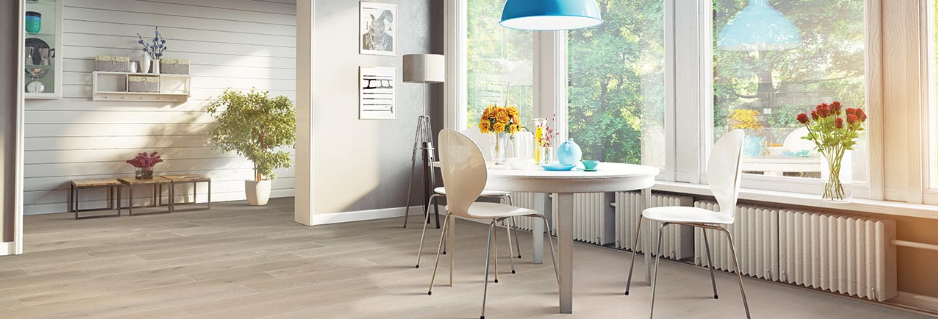 Light colored wood-look floors add brightness to a large, well-lit kitchen.